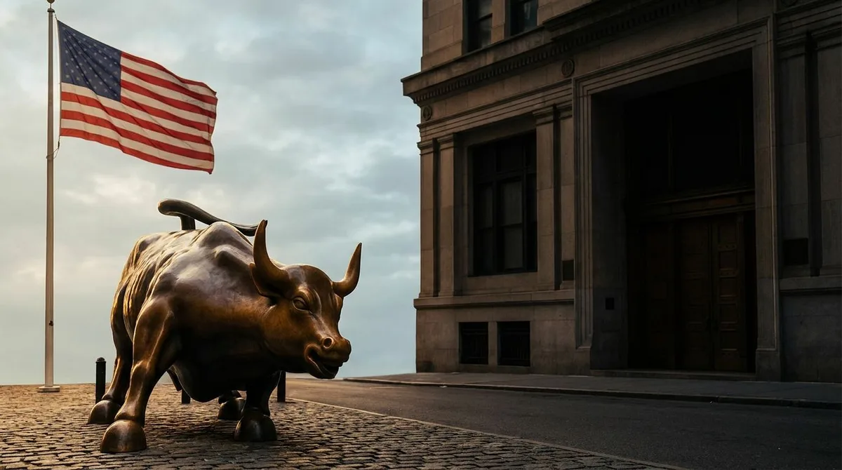 A split-scene image showing the iconic Wall Street bull statue standing quiet and still beneath a soft, hazy Memorial Day sky, with an American flag gently waving in the background.